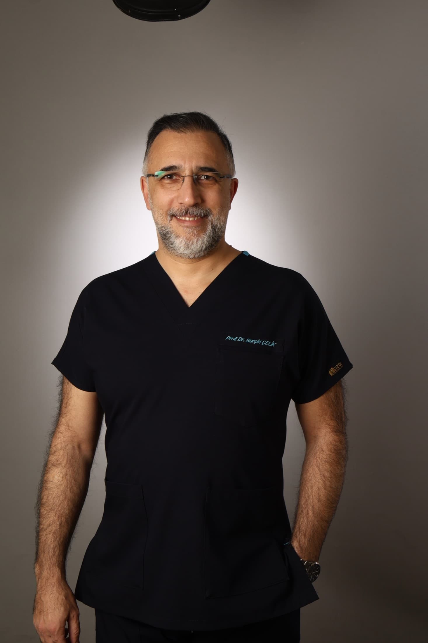 Prof. Dr. Burçin Çelik siyah cerrahi formayla stüdyo portresi